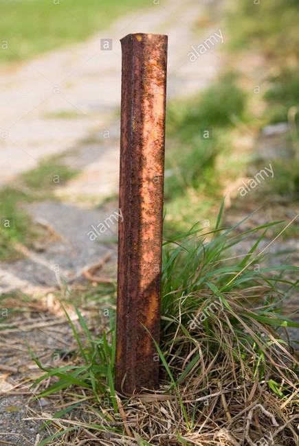 rusty-metal-pole-used-as-a-doorstop-BE8483.jpg