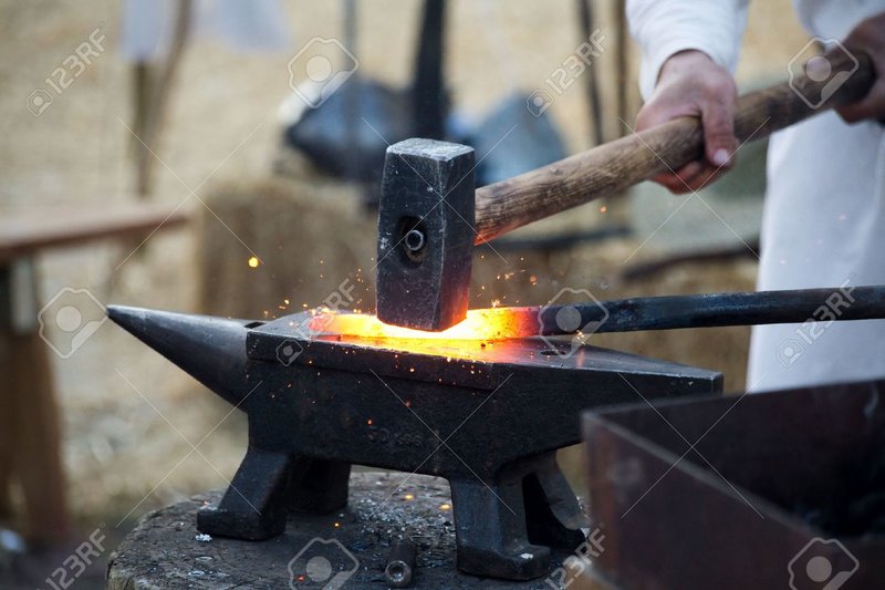 29256584-blacksmith-working-metal-with-hammer-on-the-anvil-in-the-forge.jpg