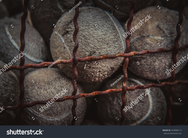 stock-photo-old-tennis-balls-in-iron-basket-rusty-iron-grate-423068113.jpg